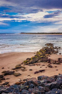 Scenic view of sea against cloudy sky