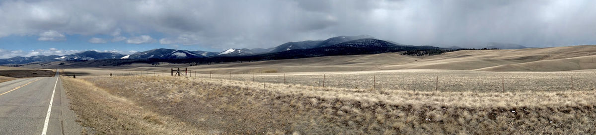 Scenic view of mountains against cloudy sky
