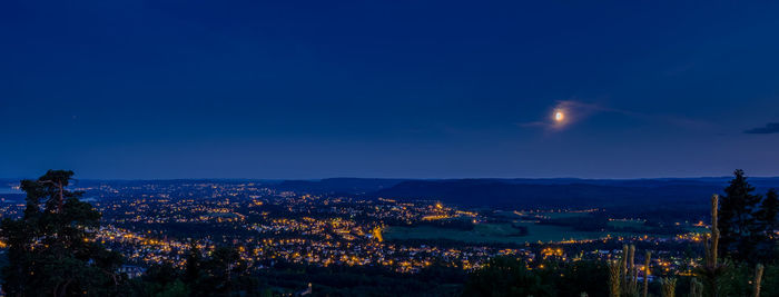 Illuminated cityscape against sky at night