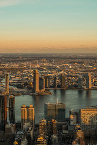 High angle view of illuminated cityscape against sky during sunset