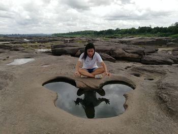 Portrait of young man on land against sky