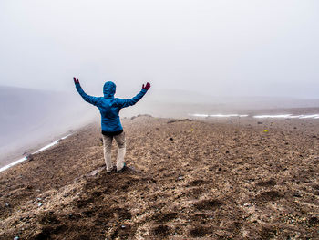 Full length of man standing on landscape against sky