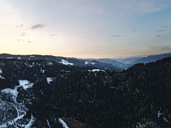 Scenic view of snowcapped mountains against sky during sunset