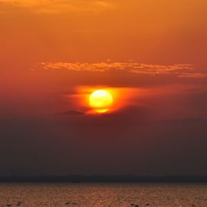 Scenic view of sea against romantic sky at sunset