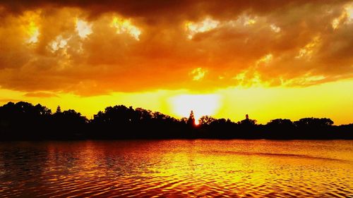 Scenic view of lake against orange sky