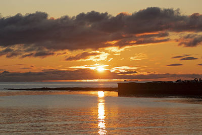 Scenic view of sea against romantic sky at sunset