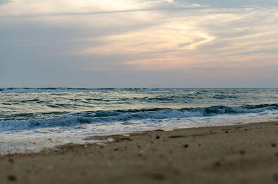 Scenic view of beach against sky during sunset