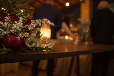 Close-up of illuminated flower pot on table at night