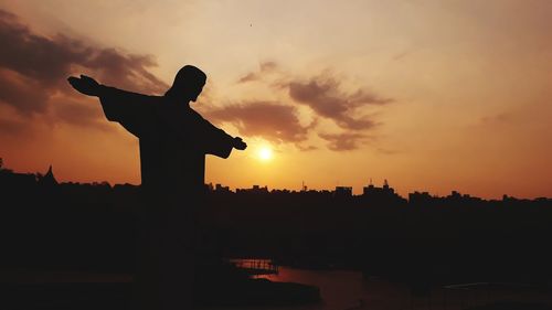 Low angle view of silhouette statue against sky during sunset