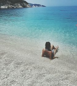 Two people sitting on beach