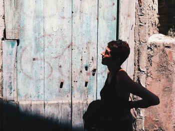 Woman standing against wall