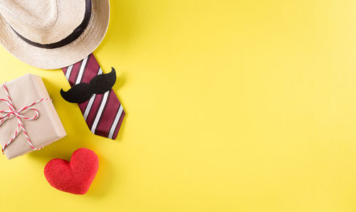 Close-up of hat against yellow background