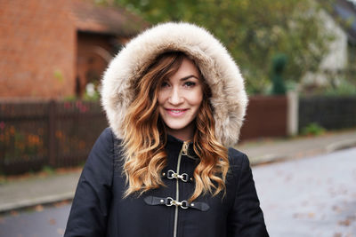 Portrait of smiling young woman wearing warm clothing