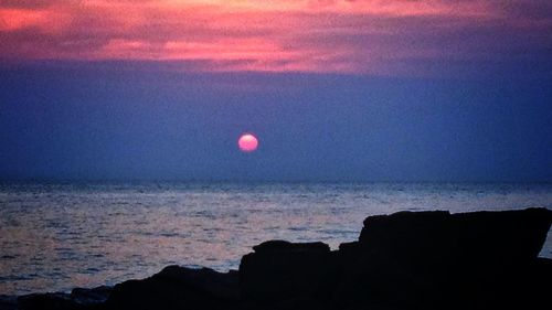 Scenic view of sea at sunset