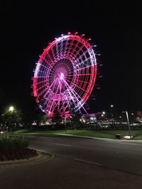 Illuminated ferris wheel at night