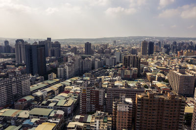 High angle view of modern buildings in city against sky