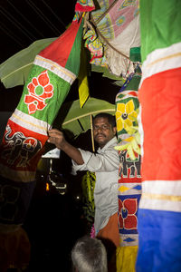 Man standing with umbrella in traditional clothing