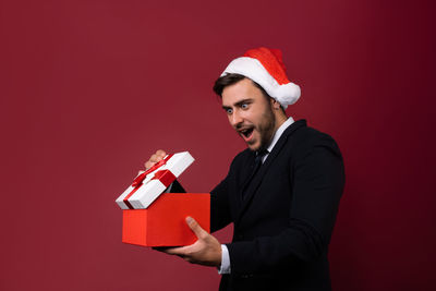 Man wearing hat against red background
