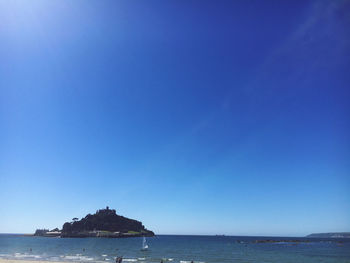 Scenic view of sea against clear blue sky