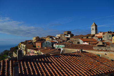 High angle view of houses in town against sky