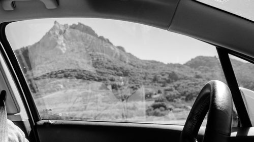 Scenic view of mountains seen through car window