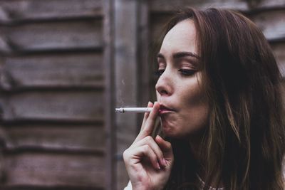 Close-up of young woman smoking cigarette