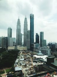 High angle view of cityscape against cloudy sky