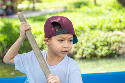 Boy rowing boat in water