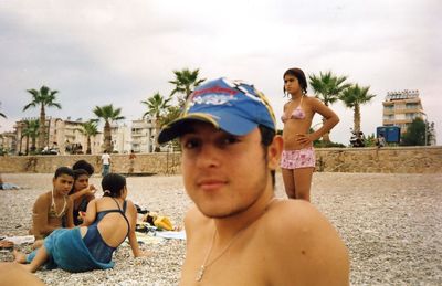 Portrait of shirtless men on beach