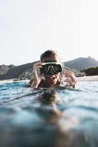 Portrait of young woman swimming in sea