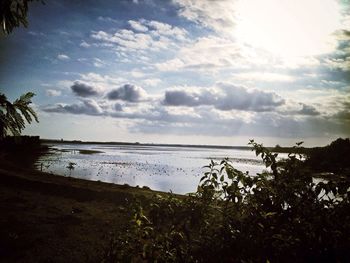 Scenic view of sea against cloudy sky