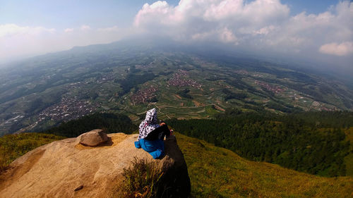 Woman on mountain against sky