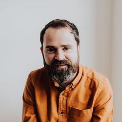 Portrait of smiling man standing against white background