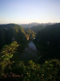 Scenic view of river amidst mountains against clear sky