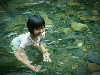 High angle view of girl standing in lake