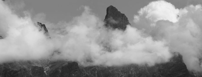 Panoramic view of smoke and mountains against sky