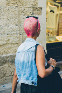 Rear view of man standing against wall