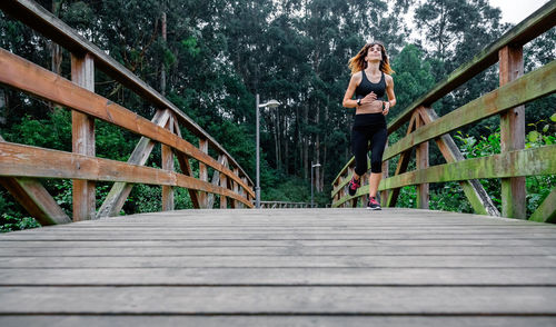 Athlete woman running through an urban park