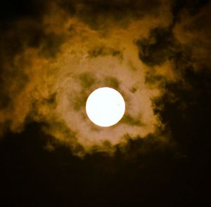 Low angle view of moon against dark sky