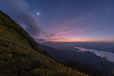 Scenic view of mountains against sky at sunset