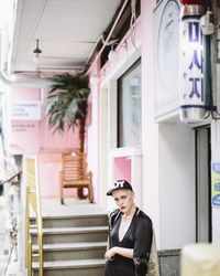 Young woman using phone while standing outdoors