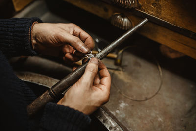 Midsection of person working on barbecue grill