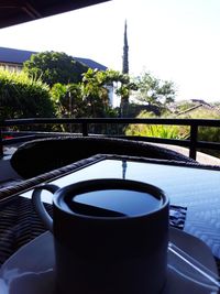 Close-up of drink by swimming pool against clear sky