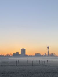 Scenic view of london across regents park against sky during a misty sunrise 