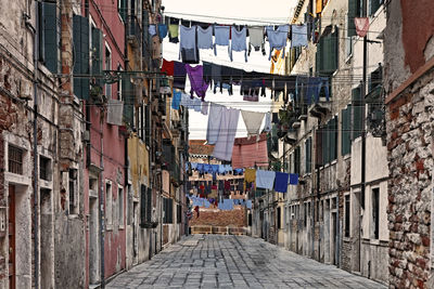 Clothes drying against buildings in city