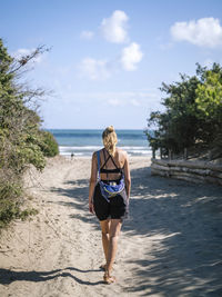 Young woman standing at beach