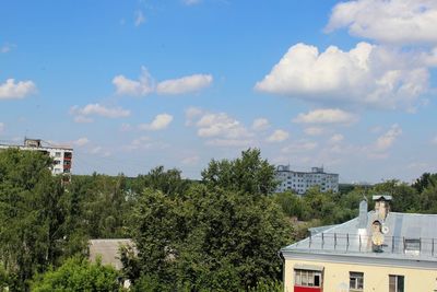 Trees and buildings against sky