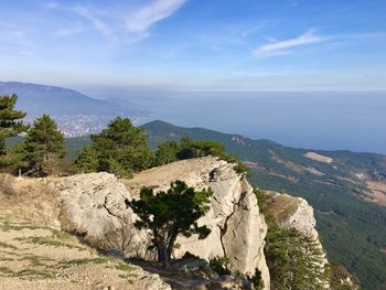 Scenic view of mountain by sea against sky