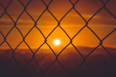 Full frame shot of chainlink fence during sunset