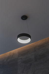 Low angle view of illuminated lamp hanging on ceiling
